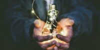 man holding incandescent bulb