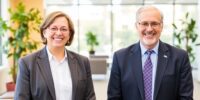 Two financial leaders in a modern office setting.