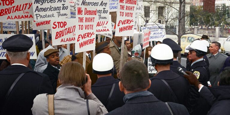 African American demonstrators outside the White House, with signs demanding the right to vote and protesting police brutality against civil rights demonstrators in Selma, Alabama