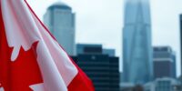 Canadian flag in a city setting during political upheaval.