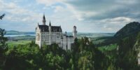 white concrete castle in green field