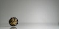 a close up of a coin on a reflective surface