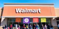 Walmart store front with shoppers celebrating its award.