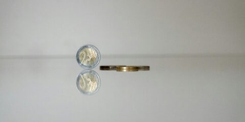 a gold ring with a coin on top of it