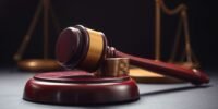 Close-up of a gavel on a wooden block.