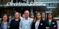 Cleveland Clinic employees outside, expressing concern over layoffs.